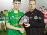 North Antrim GAA Chairmain Owen Elliott presentring Cuchullains captain Aaron Crawford with the North Antrim U16A Championship Final Shield