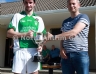 North Antrim GAA Secretary Frank McCarry presenting Con Magees Glenravel captain Mark O’Connor with the Junior Feis Gaelic Football Trophy