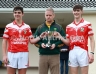 North Antrim GAA Chairman Owen Elliott presenting joint Loughgiel Shamrocks captains Cathal Hargan and Michael McGarry with the McMullan Cup Final Trophy