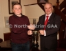 Antrim County Vice-Chairman Joe Edwards presents the U14 Championship Cup to Loughgiel captain Declan McCloskey
