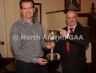 Antrim Vice-Chairman Joe Edwards presents the North Antrim Junior Feis Gaelic Football trophy to Michael Hardy of St Mary’s Rasharkin