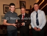 Antrim County Vice-Chairman Joe Edwards presents the North Antrim U14B League to Dan O'Boyle (left) and John Rosborough of St MacNissi