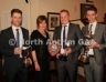 North Antrim Secretary Mary Kane presents Loughgiel Shamrocks trio Nicholas McNaughton (left) with the Reserve Championship Cup, Damian Gillen with the North Antrim Junior League and McCaughan Cup and James McNaughton with the Alister McAlister Cup