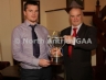 Antrim County Vice-Chairman Joe Edwards presents the Junior Hurling Championship Cup to Declan McKay of St Mary's, Rasharkin
